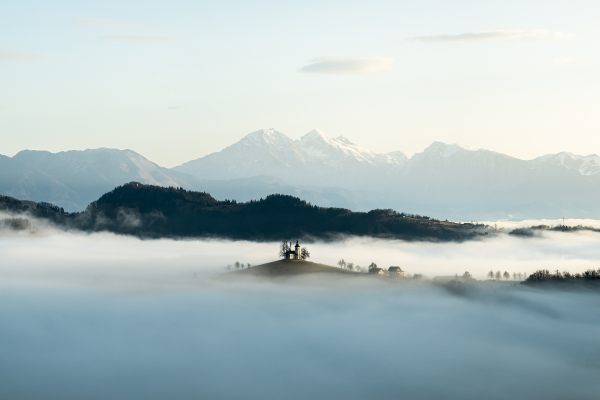 Cloud covered snowy mountains